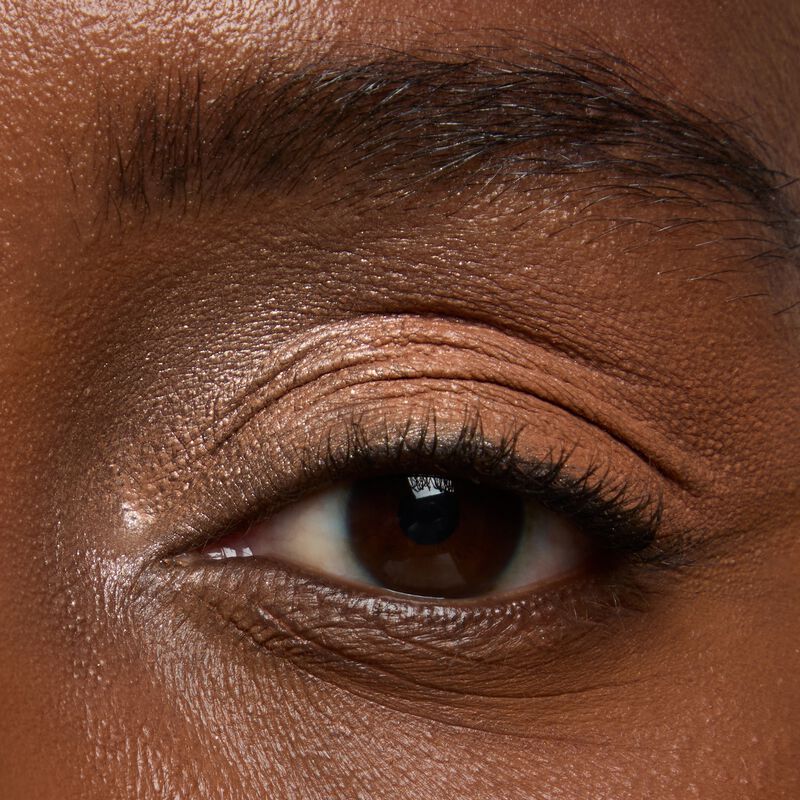 Deepskinned model wearing Mary kay Eye Shadow Sticks in shades Golden Sunrise and Orbit Clay